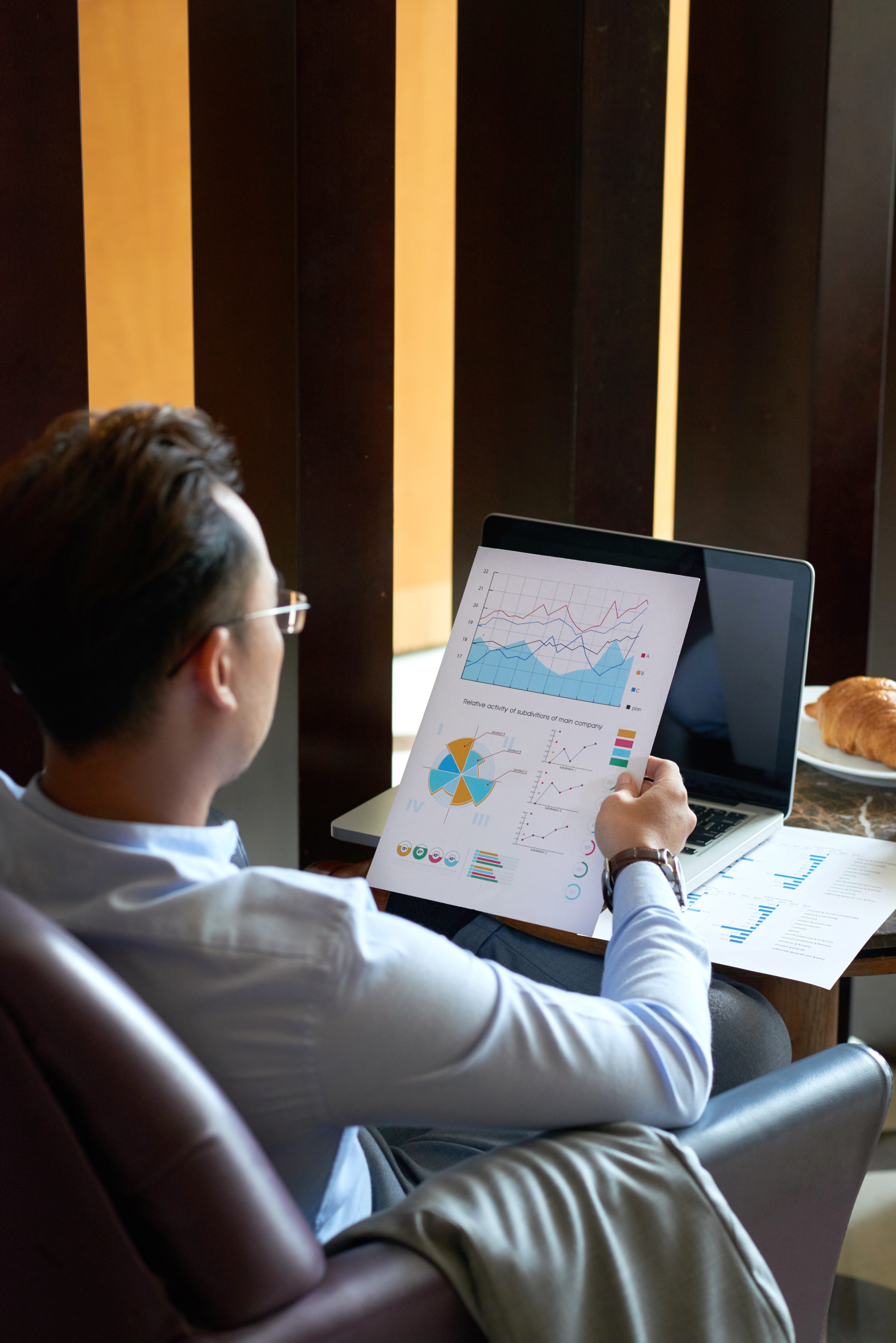 Entrepreneur looking at document with diagram in his hand